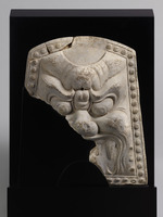 Ridge-end tile depicting a demon’s face in reliefimage